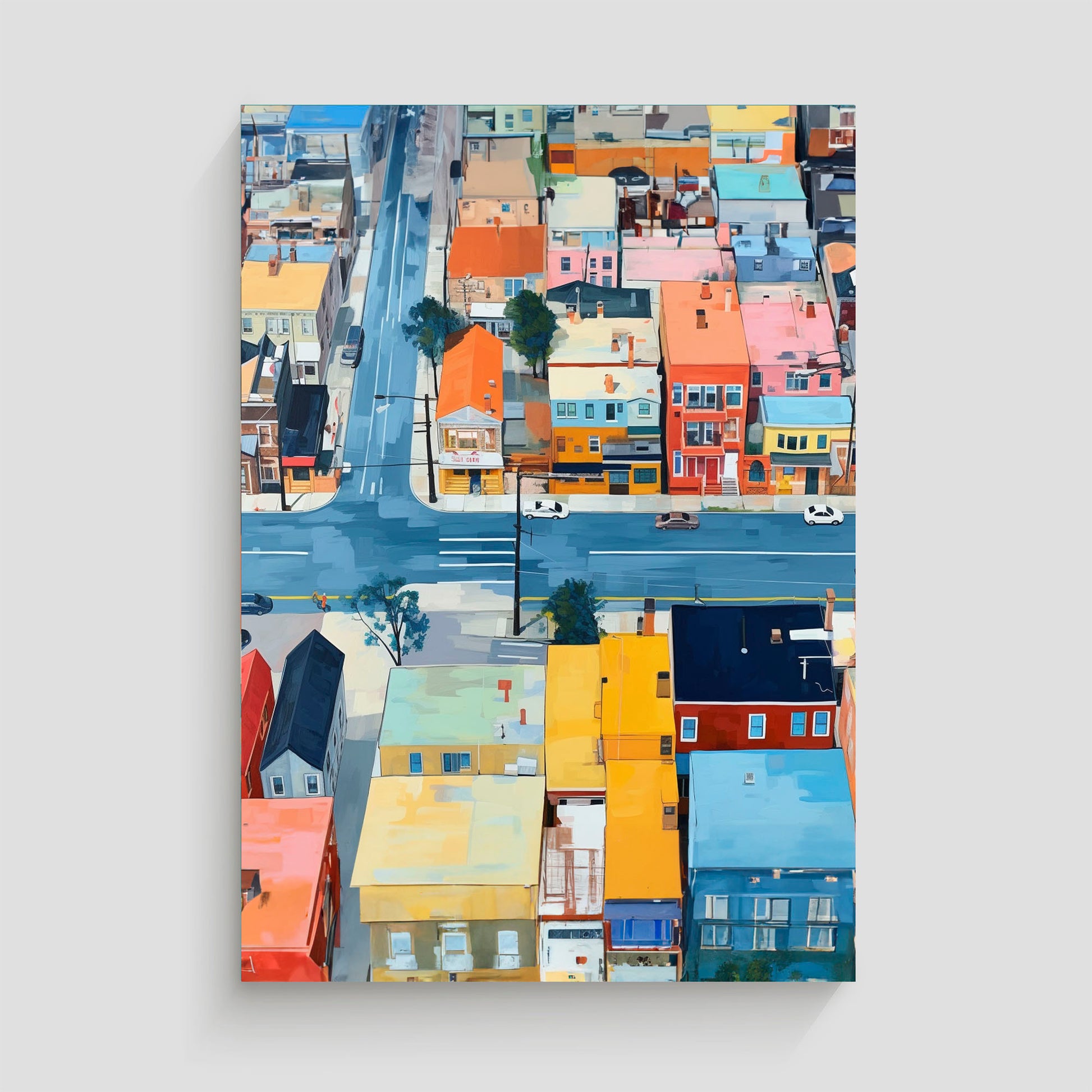 Imagen aérea de un barrio urbano con edificios de colores vivos y calles transitadas, mostrando intersecciones y coches circulando.